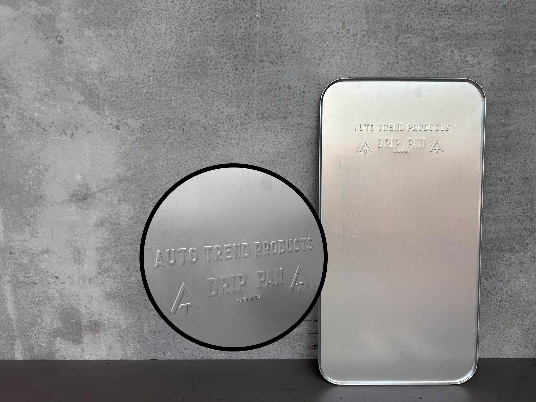 Aluminum drip tray with classic design - close-up shows the embossed text on the tray.